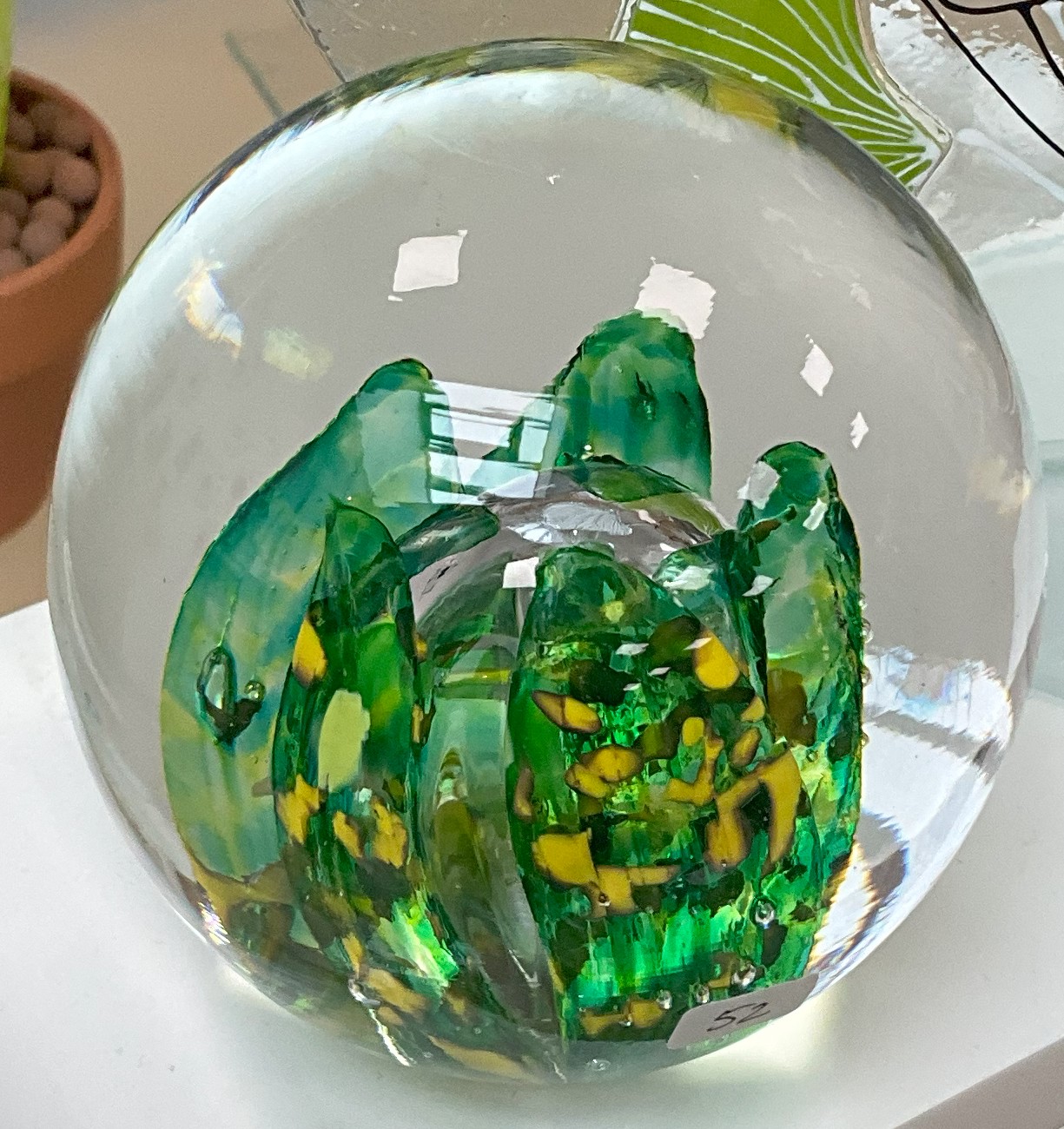 Close-up of the sulphure paperweight’s internal motif, showing fine colour powder inclusions and the clear encasing layer.